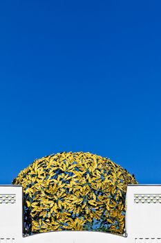 A golden cupola consisting of metal laurels on a museum in Vienna