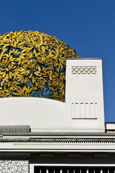 A golden cupola of laurels on an aged building in Vienna, Austria