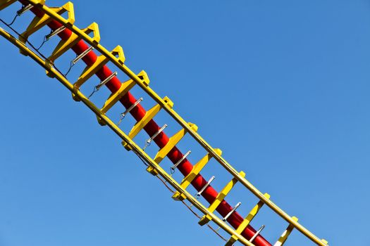 A helix for a roller coaster in red and yellow with scratches; shot in Vienna's amusement park