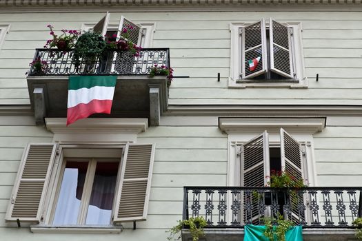 An Italian house facade decorated with flags after celebrating a national holiday