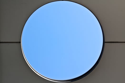 A hole in a public building offering a view to the blue sky
