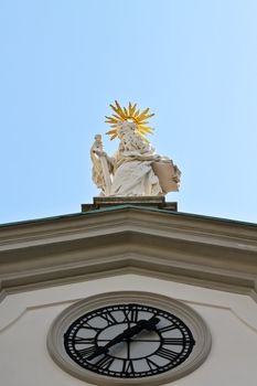 A sculpture of a saint with a sword and a book on a church in the center of Vienna