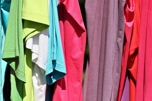 A set of bright t-shirts on an outdoor market in Vienna