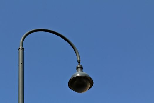 A modern street lamp on a street in Vienna with a round shape