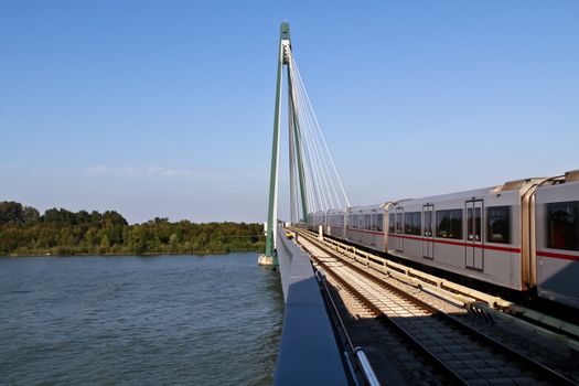 An underground train passes a bridge in the outskirts of Vienna