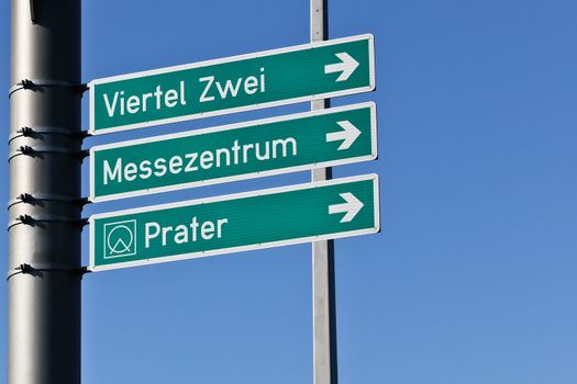 Signs for traffic on a large public street in Vienna leading to famous destinations