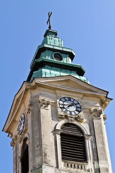 A tower of an old church with a clock needs renovation