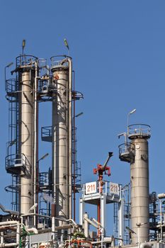 Three industrial tanks with a fire extinguisher in an industrial area of Vienna