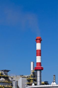 An industry chimney operating on a low level in an industrial area close to Vienna