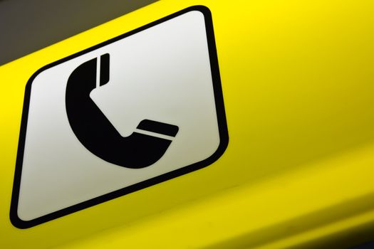 A lighted sign for a telephone booth at the airport of Vienna