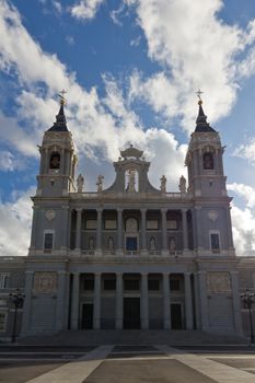 Madrid's cathedral on a cloudy day with the entrance in the shadow