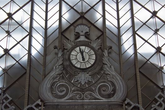 An old large clock at the central station in Madrid