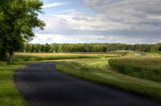 This photo present double bend on the road leading to the overpass over the highway HDR.