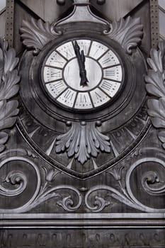 An old large clock at the central station in Madrid