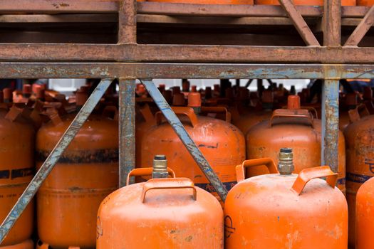 A set of stacked propane cartridges in a container