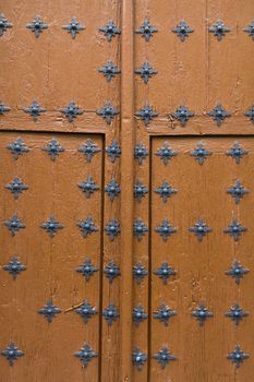 An old spanish door with metal details in Segovia, Spain