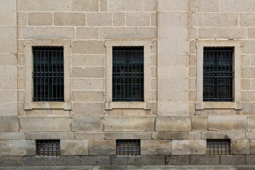 Symmetric windows on in an old wall in El Escorial, a famous spanish monastery