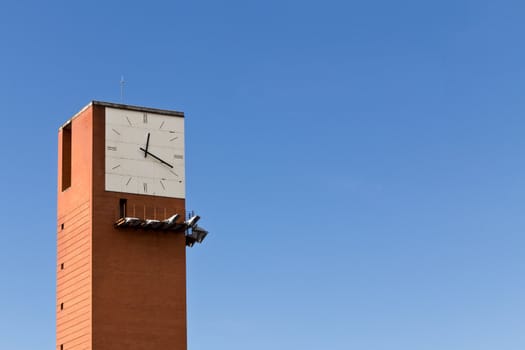 A clock tower next to Madrid's central station on clear blue sky