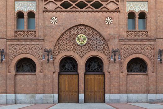 A brick entrance to a spanish bullfight arena with an arabic touch