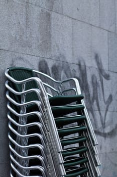 Wet stacked chairs next to a market in the center of Madrid