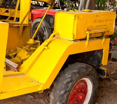 Yellow tractor. A view from the side of the car.