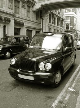 Classic London cab on the street. Old Sepia toned photo.