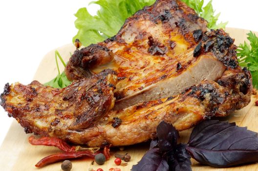 Barbecue Pork Ribs with Lettuce, Basil and Spices closeup on Cutting Board