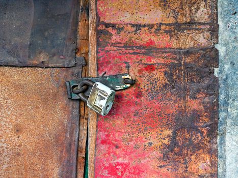 Old vintage padlock on the door of the barn
