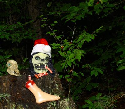 The Grim Reapers head arising from a stump in the woods along side of a Deer Skull with room for your text.