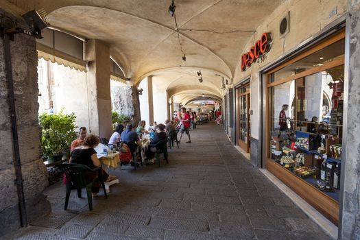 GENOA, ITALY - June 16: Tourists and locals rests in sidewalk cafes in Genoa, Italy on June 16, 2012, Genoa, Italy.