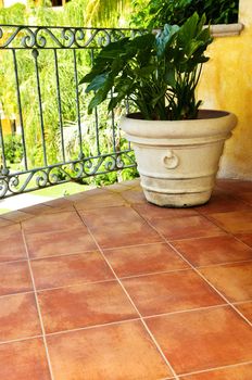 Tiled Mexican balcony with potted plant near railing