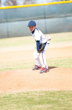 Little league baseball player about to pitch.
