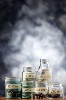 Bottles of cash with coins isolated on the background.