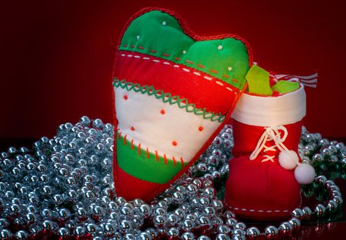 Christmas decorations with silver beads on red background 