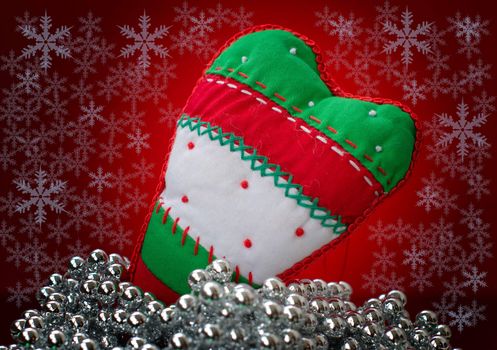 Christmas decorations with silver beads on a background of falling snowflakes