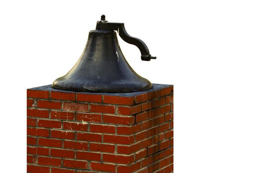 An old large church bell on a brick pedestal isolated on white with room for your text.