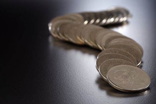 Row of coins on the black background.