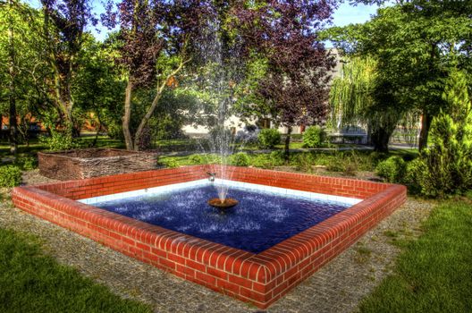 This photo present fountain. Wicker enclosed fountain pump HDR.