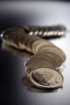 Row of coins on the black background.