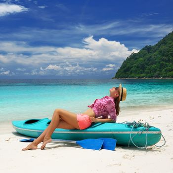 Woman in sunglasses at beach wearing hat