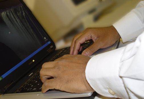 business man typing on laptop