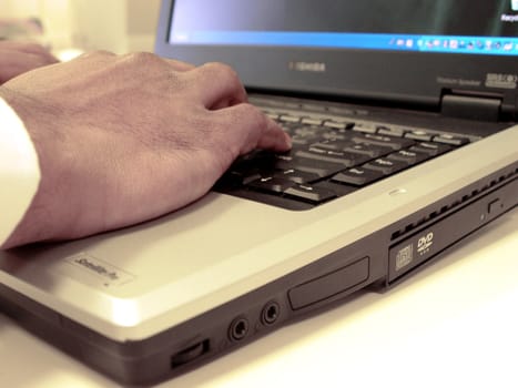 business man typing on laptop