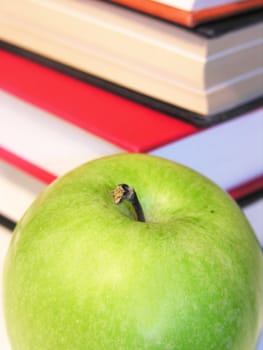 green apple with books