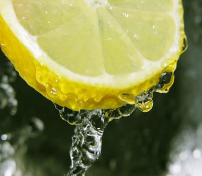 Water dripping off a lemon slice