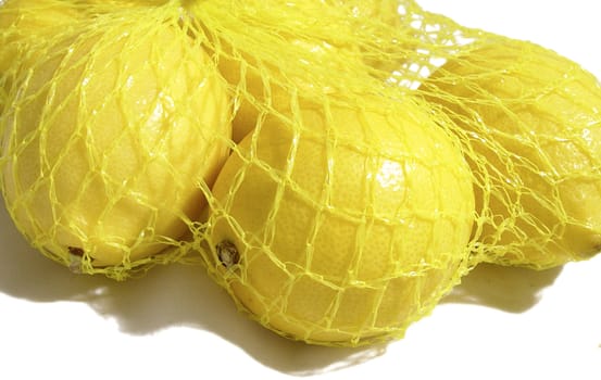 close up of lemons in fishnet bag