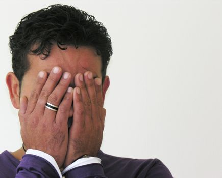 a man covering his face with his hands