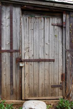 closed wooden door of old decay shed
