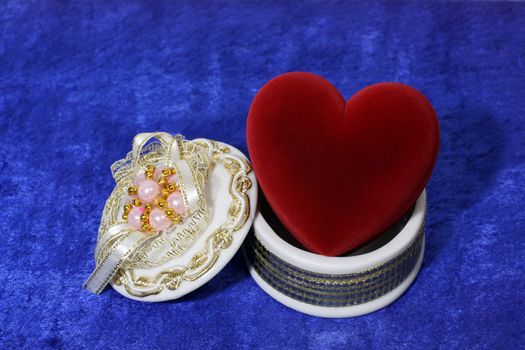 valentine day - big red heart in open box on blue velvet