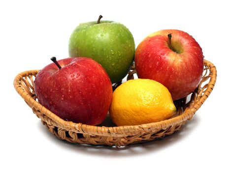 basket with wet fruits isolated on white