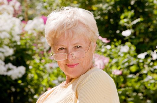 Portrait of the elderly laughing woman in glasses
